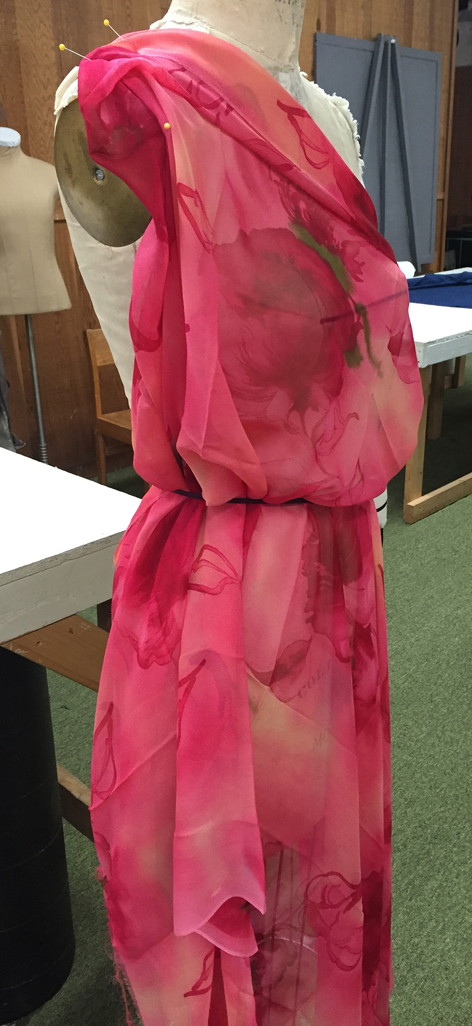 Pink floral silk chiffon draped over a dress form.