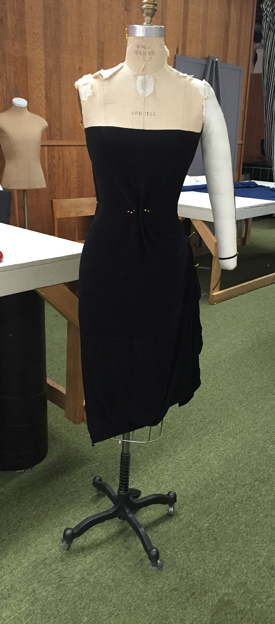 Black knit fabric draped over a dress form.